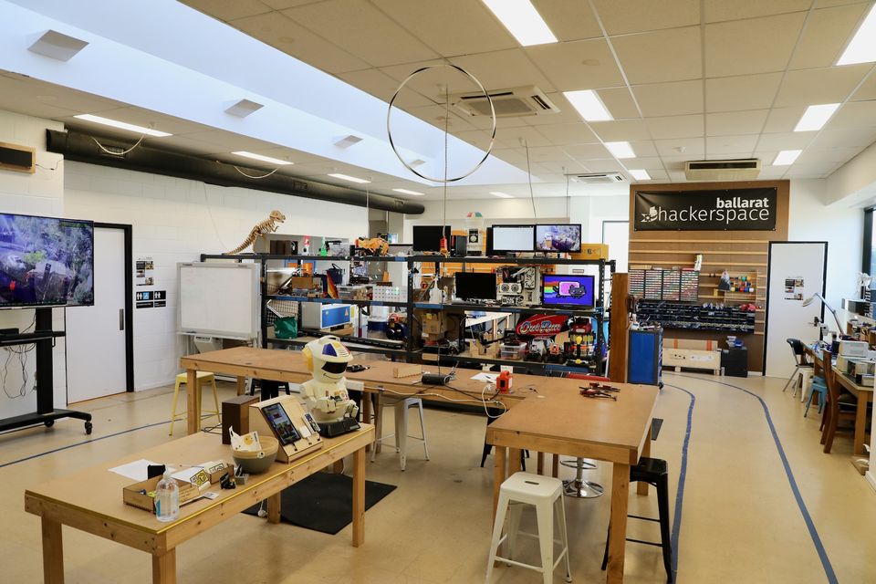 The main workshop floor with benches, parts storage and an arcade cabinet